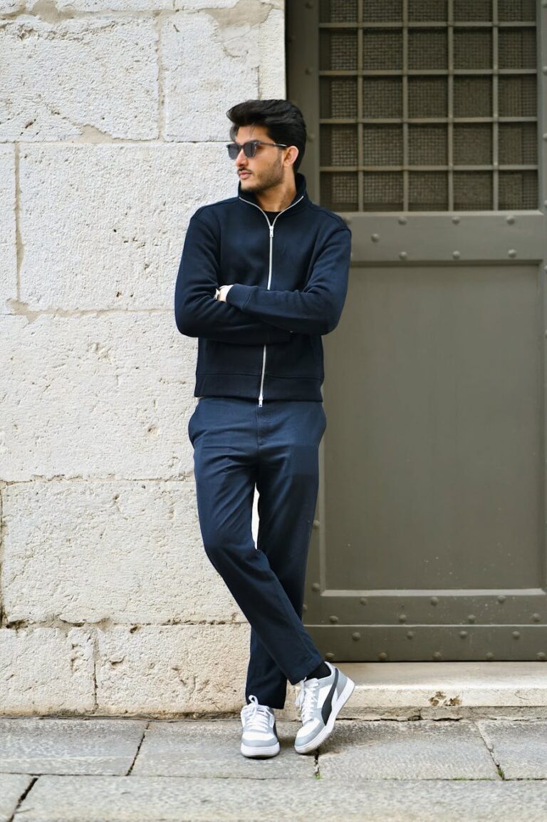 stylish man posing by historic wall in italy