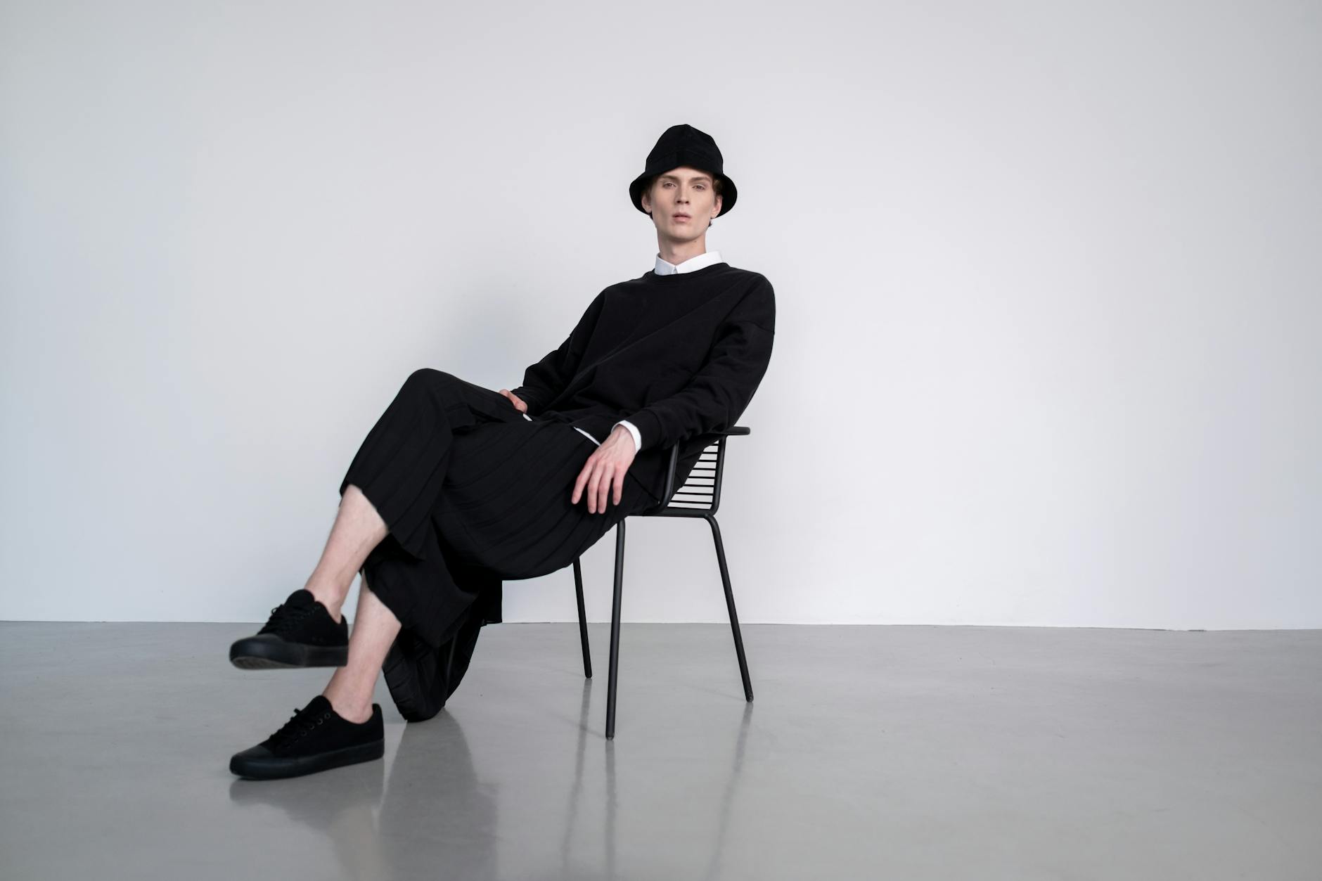 man in black long sleeves sitting on the chair
