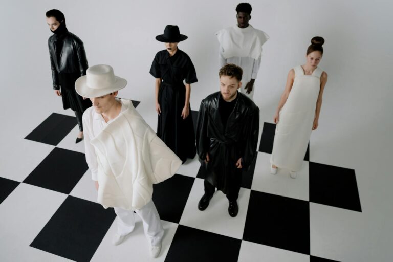 group of people standing on chess themed floor